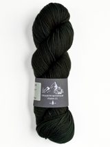 Dark green skein of yarn with a label on a white background