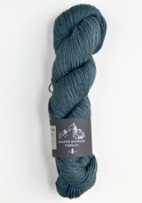 Blue skein of yarn with a label on a white background