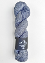 Blue skein of yarn with a label on a white background