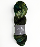 Green skein of yarn with a label on a white background