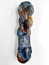 Multicolored skein of yarn with a label on a white background