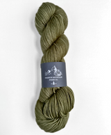 Olive green skein of yarn with a label on a white background