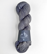Gray skein of yarn with a label on a white background