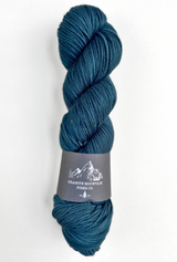 Blue skein of yarn with a label on a white background