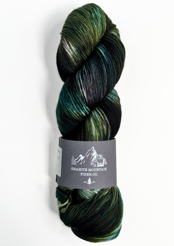 Green skein of yarn with a label on a white background