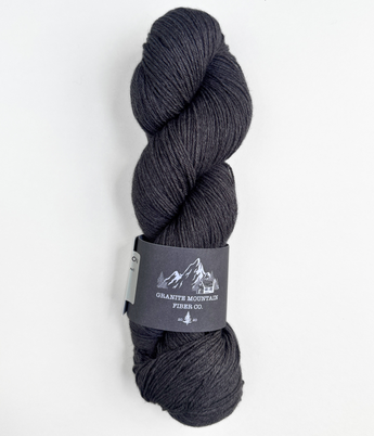 Gray skein of yarn with a label on a white background
