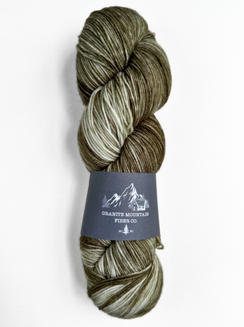 Skein of multicolored yarn with a label on a white background