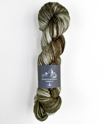 Skein of multicolored yarn with a label on a white background