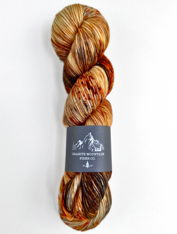 Multicolored skein of yarn with a label on a white background