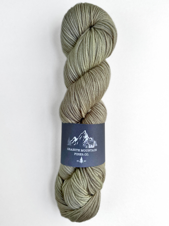 Green skein of yarn with a label on a white background