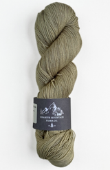 Green skein of yarn with a label on a white background