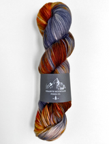 Multicolored skein of yarn with a label on a white background