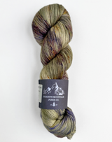 Multicolored skein of yarn with a label on a white background