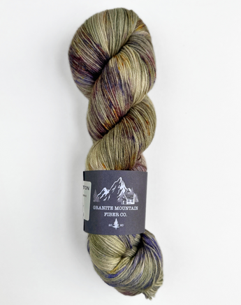 Multicolored skein of yarn with a label on a white background
