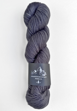Gray skein of yarn with a label on a white background