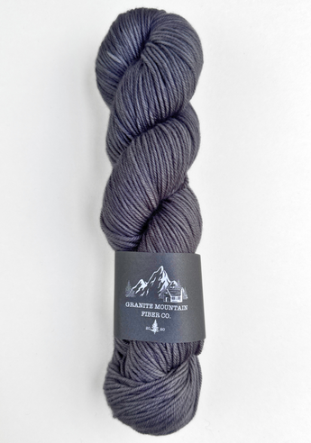 Gray skein of yarn with a label on a white background