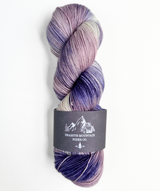 Multicolored skein of yarn with a label on a white background