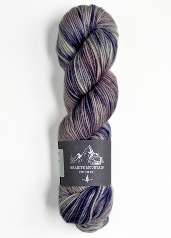 Multicolored skein of yarn with a label on a white background