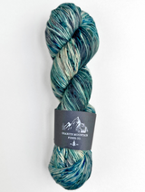 Multicolored skein of yarn with a label on a white background